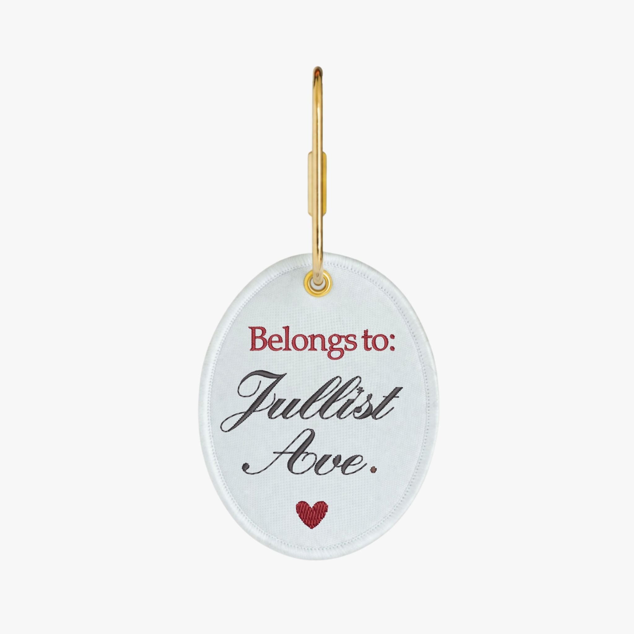 Personalized embroidered keychain in white with red lettering and gold ring.