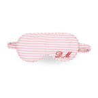 Pink striped sleep mask with personalized embroidery 'D.M.' for restful sleep.
