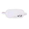 Striped silk sleep mask with personalized embroidery, perfect for comfortable rest and relaxation.