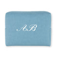 Personalized blue cosmetic pouch made of durable fabric with elegant white initials A.B.