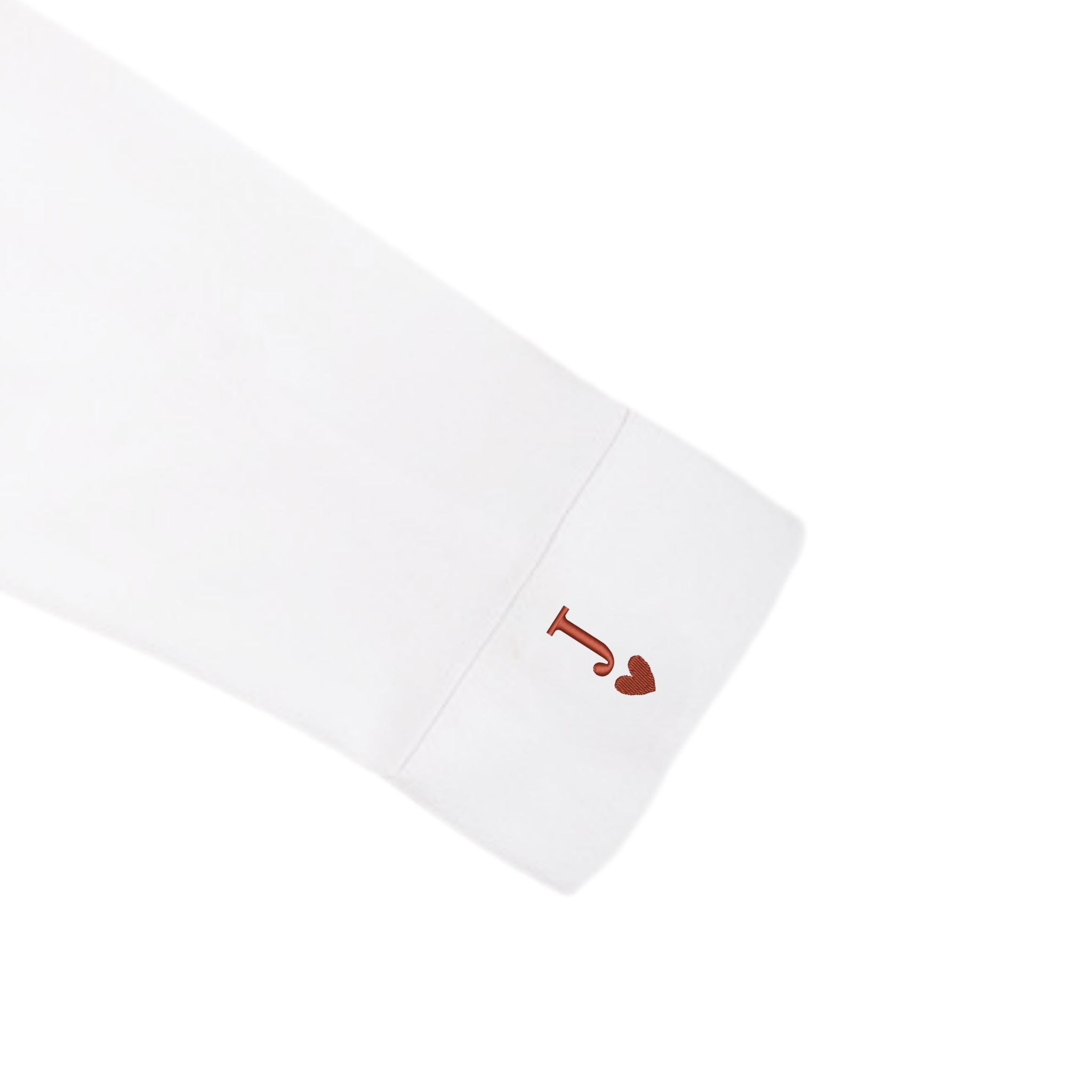 White long-sleeve shirt featuring a stylish red 'J' heart logo on the cuff.