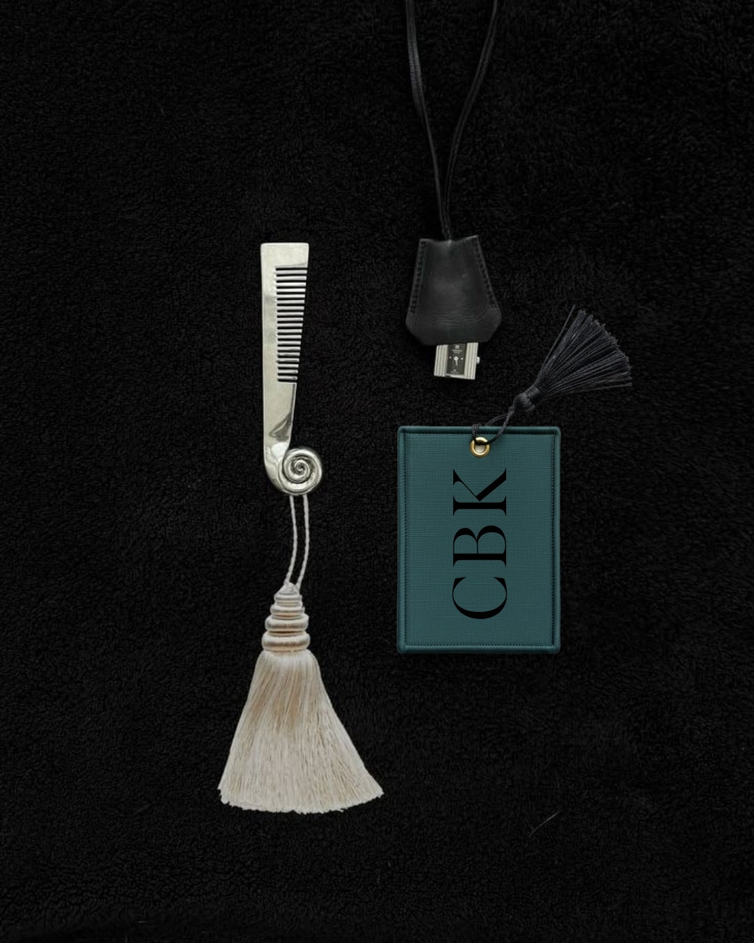 Stylish silver hair comb with tassel and leather USB tag, featuring a chic green design with 'CBK' logo.