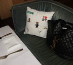 Decorative throw pillow featuring NYC motifs, white cotton fabric, perfect for chic home decor.