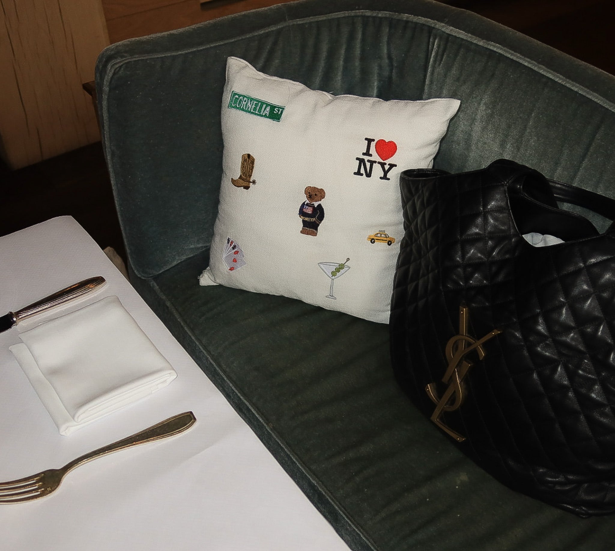 Decorative throw pillow featuring NYC motifs, white cotton fabric, perfect for chic home decor.