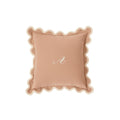 Personalized blush pink pillow with scalloped edges and embroidered 'A' monogram.