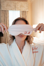 Personalized pink striped silk eye mask for sleep, elegantly embroidered with initials D.M.