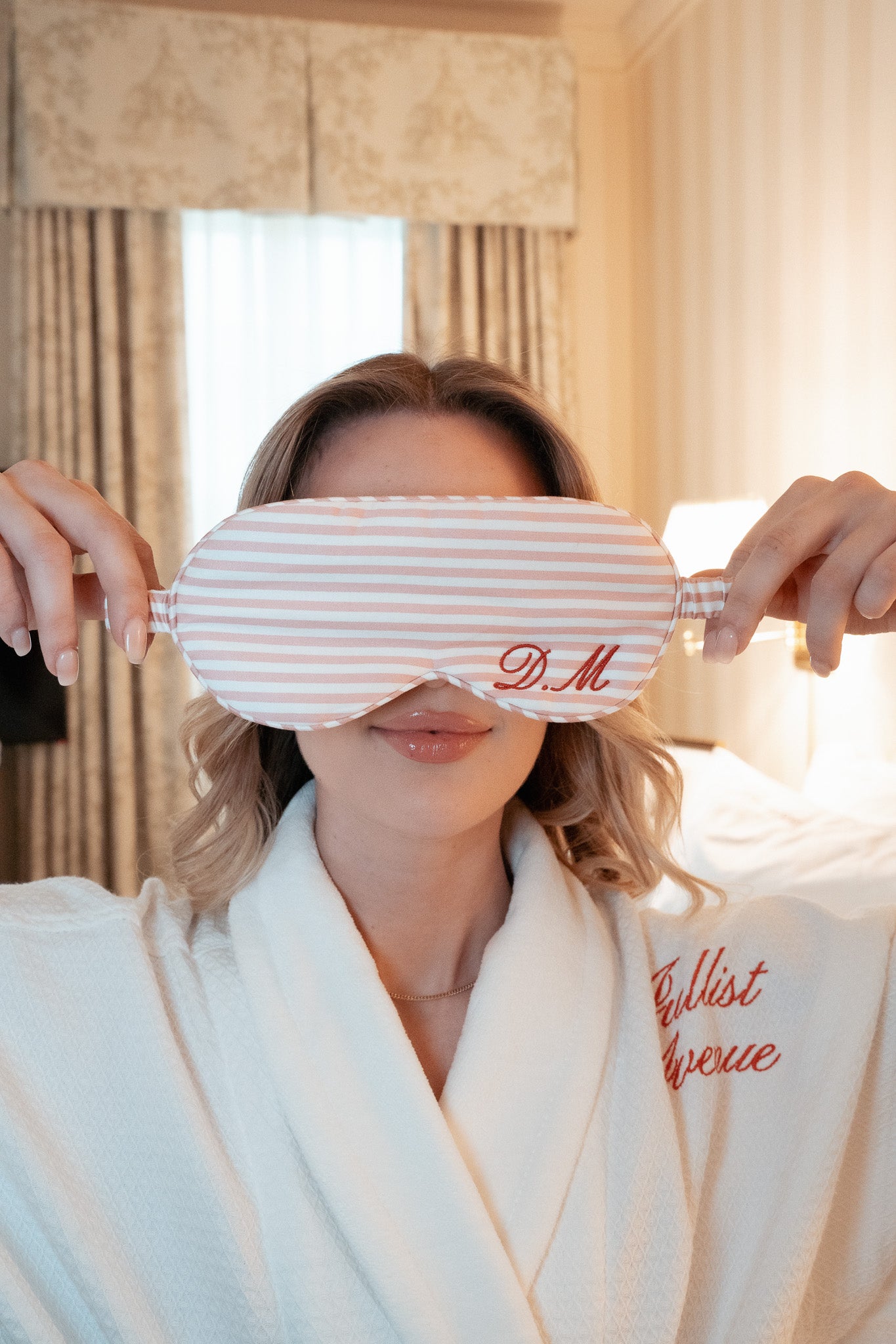 Personalized pink striped silk eye mask for sleep, elegantly embroidered with initials D.M.