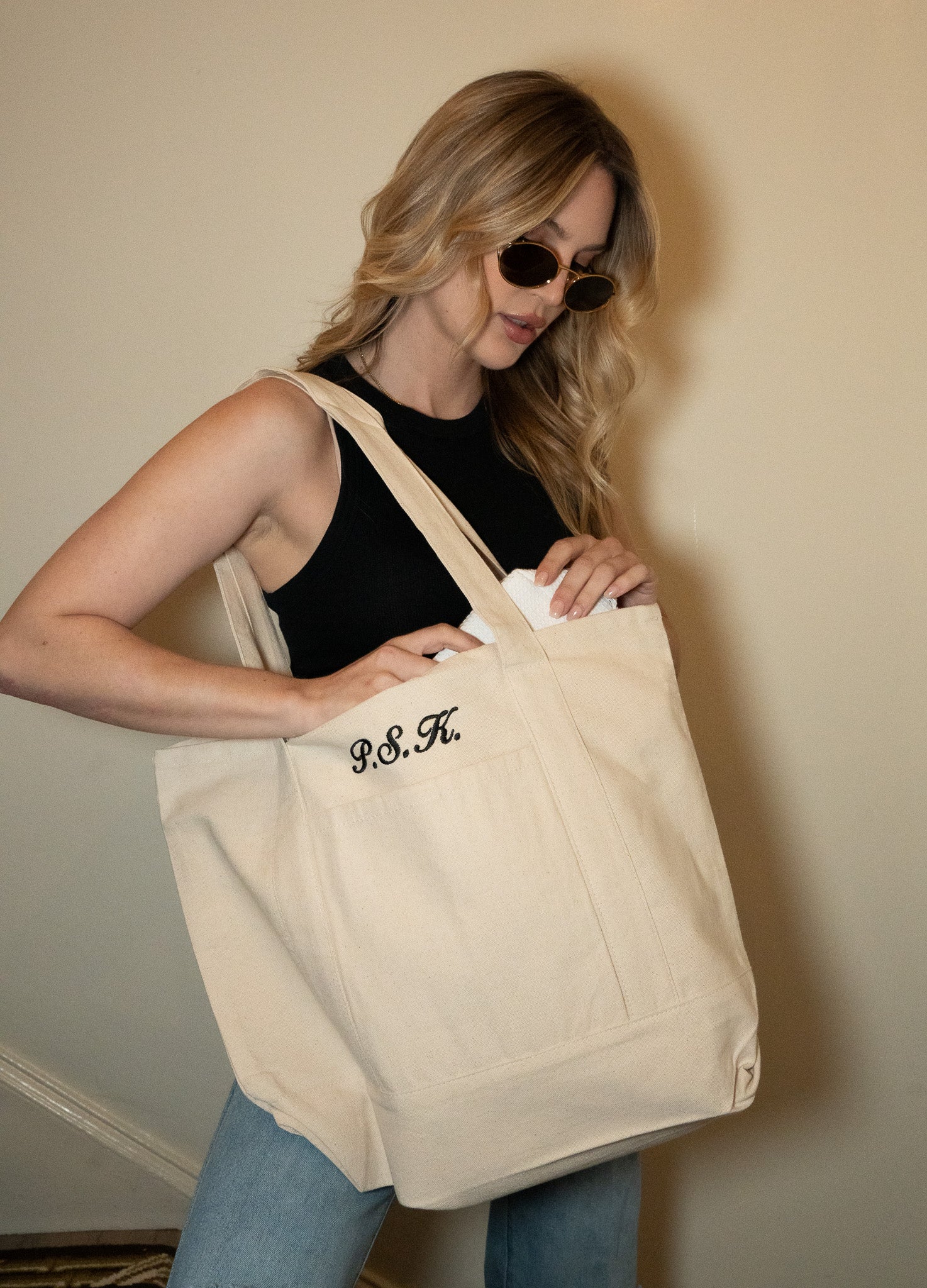 Beige canvas tote bag with personalized embroidery, perfect for casual outings or shopping.