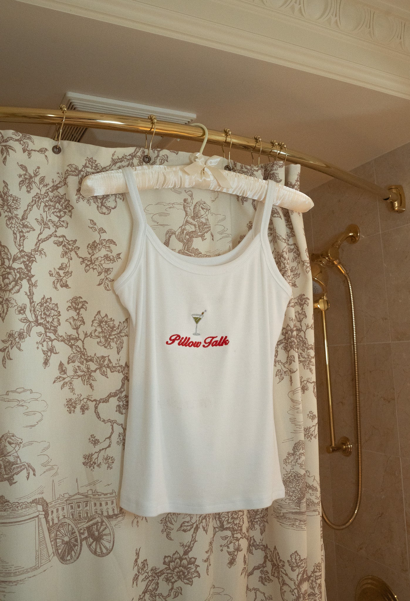 White ribbed tank top with 'Pillow Talk' embroidery and martini graphic, perfect for casual lounging.