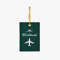 Green luggage tag with 'Mr. Worldwide' embroidery and airplane design, perfect for stylish travel.