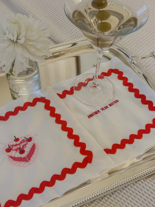 Vintage embroidered cocktail napkin set, white fabric with red scalloped trim and birthday cake design.