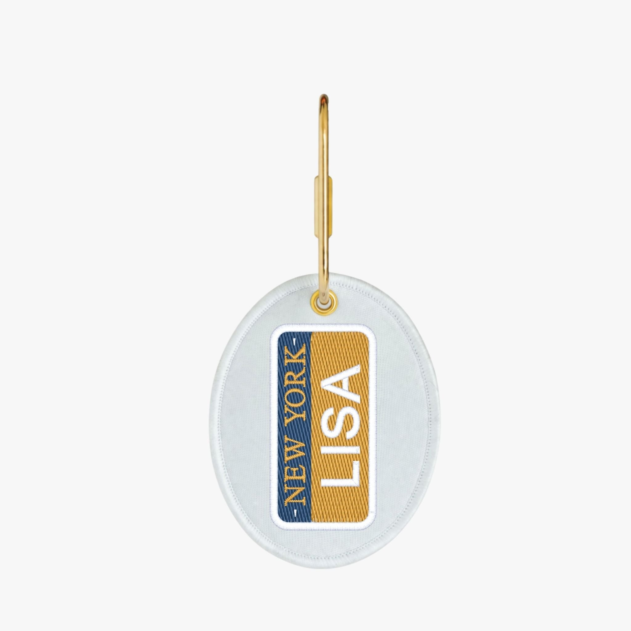 Personalized New York keychain with gold accents and white backing, featuring the name 'LISA'.