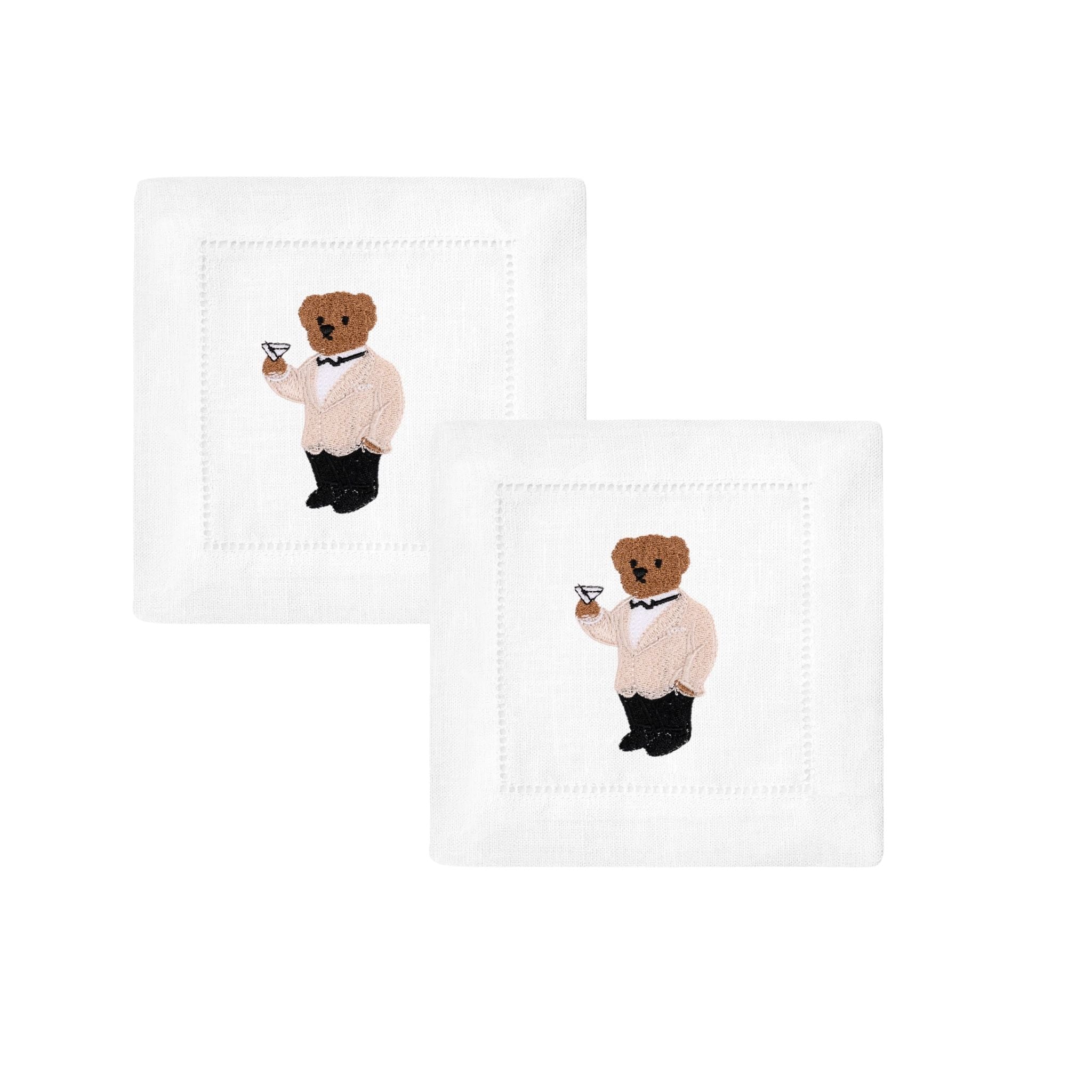 Set of two white linen napkins with embroidered bear in formal attire holding a cocktail.