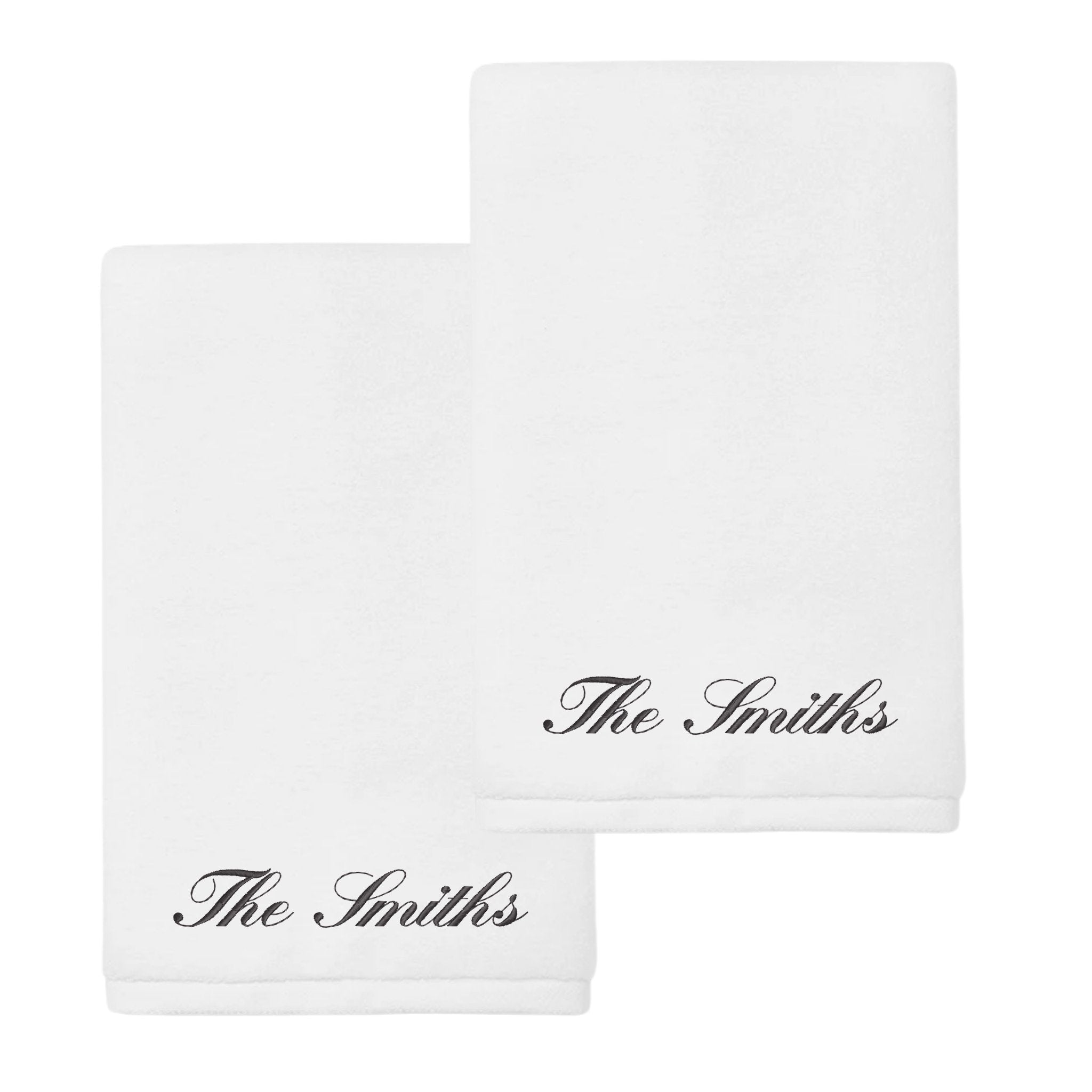 Personalized white towels set with 'The Smiths' embroidered in elegant black script.