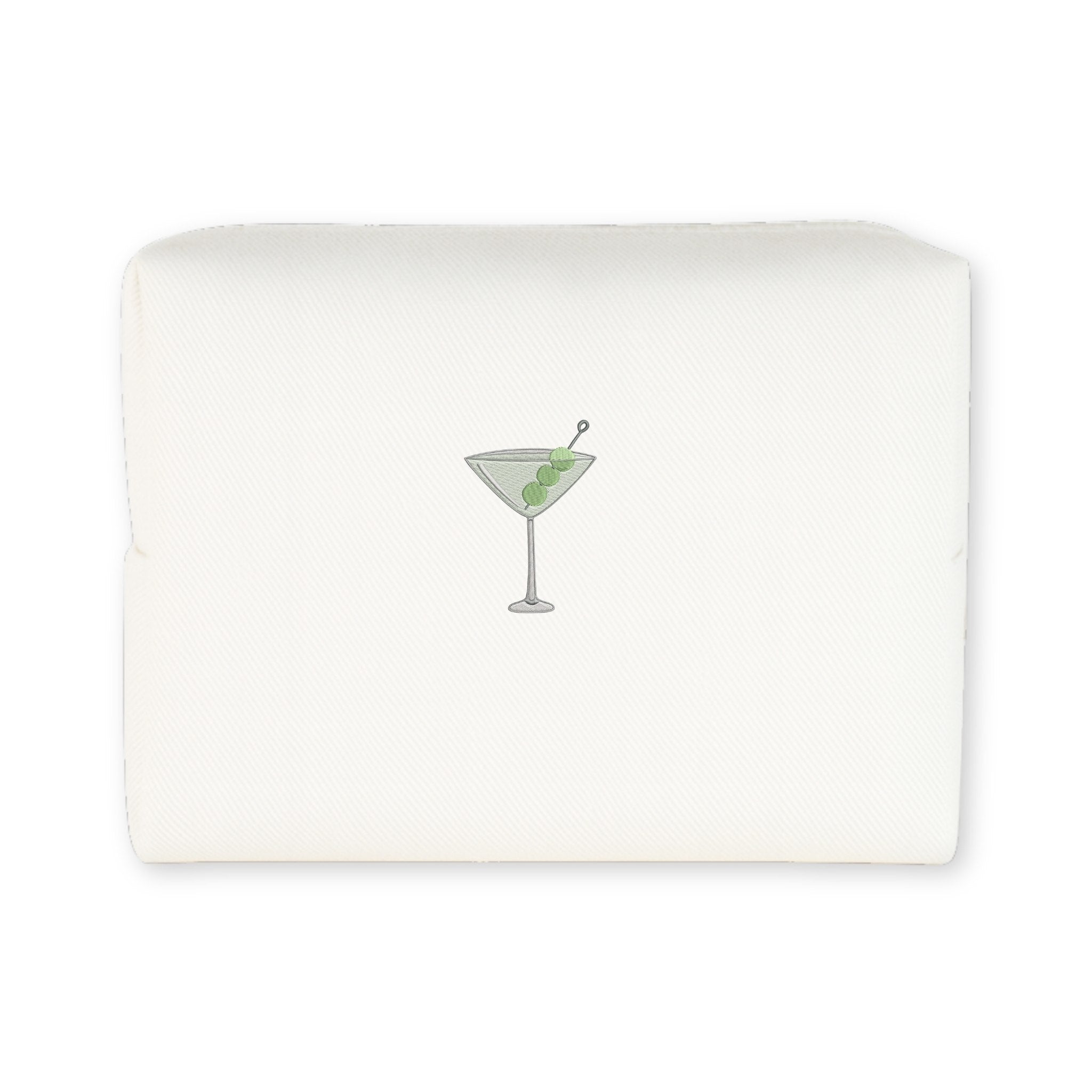 Embroidered cocktail napkin featuring a martini glass with olives, elegant cream color.