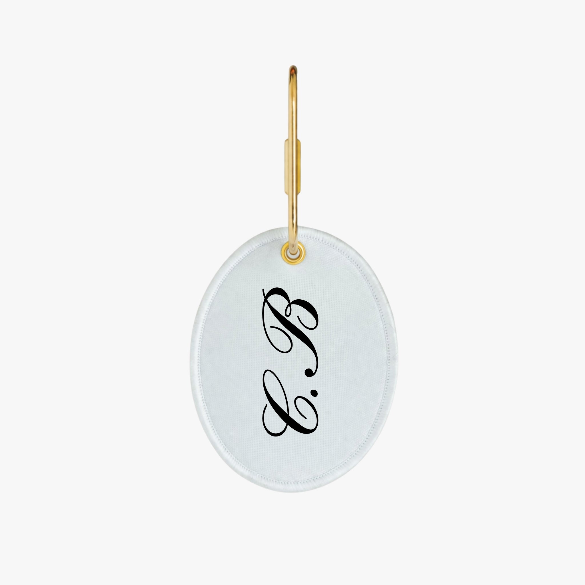 Personalized white oval keychain with black monogram initials and gold keyring.