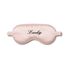 Pink sleep mask with 'Lucky' text on a white background