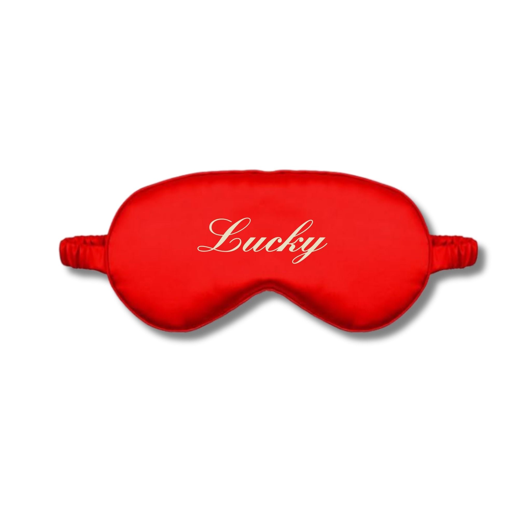 Red silk eye mask with 'Lucky' embroidery for restful sleep and relaxation.