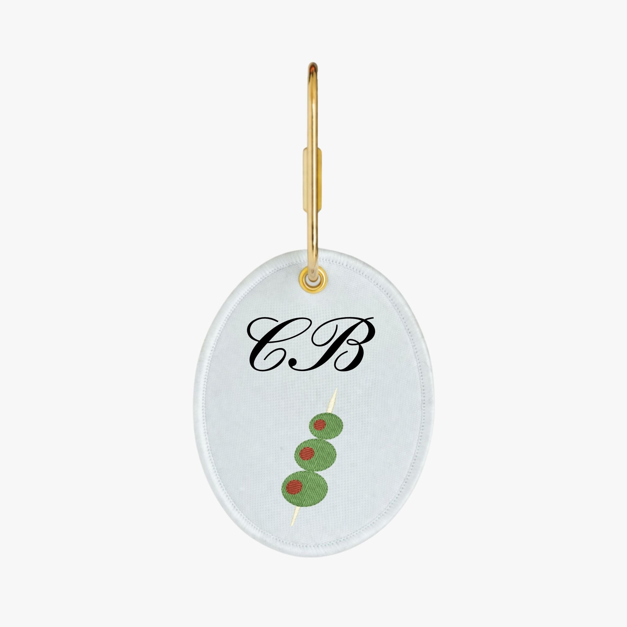Personalized monogram keychain featuring green olives on a skewer, gold-tone hardware, and white background.