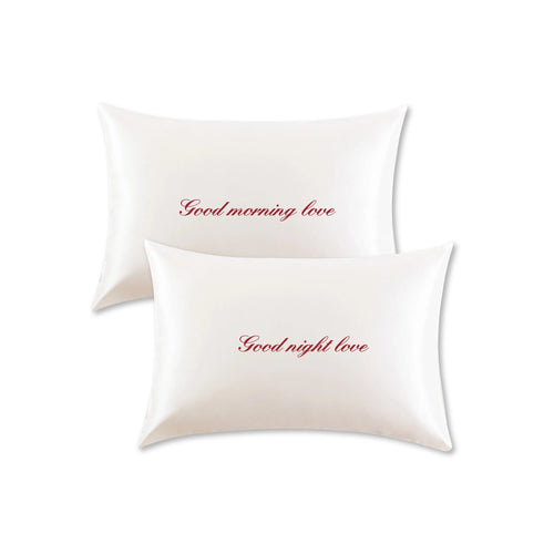 Two white pillows with red text 'Good morning love' and 'Good night love' on a white background